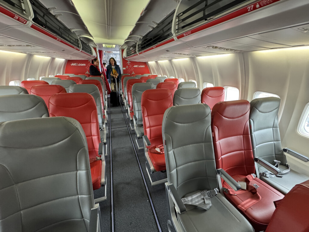 a plane with red and grey seats