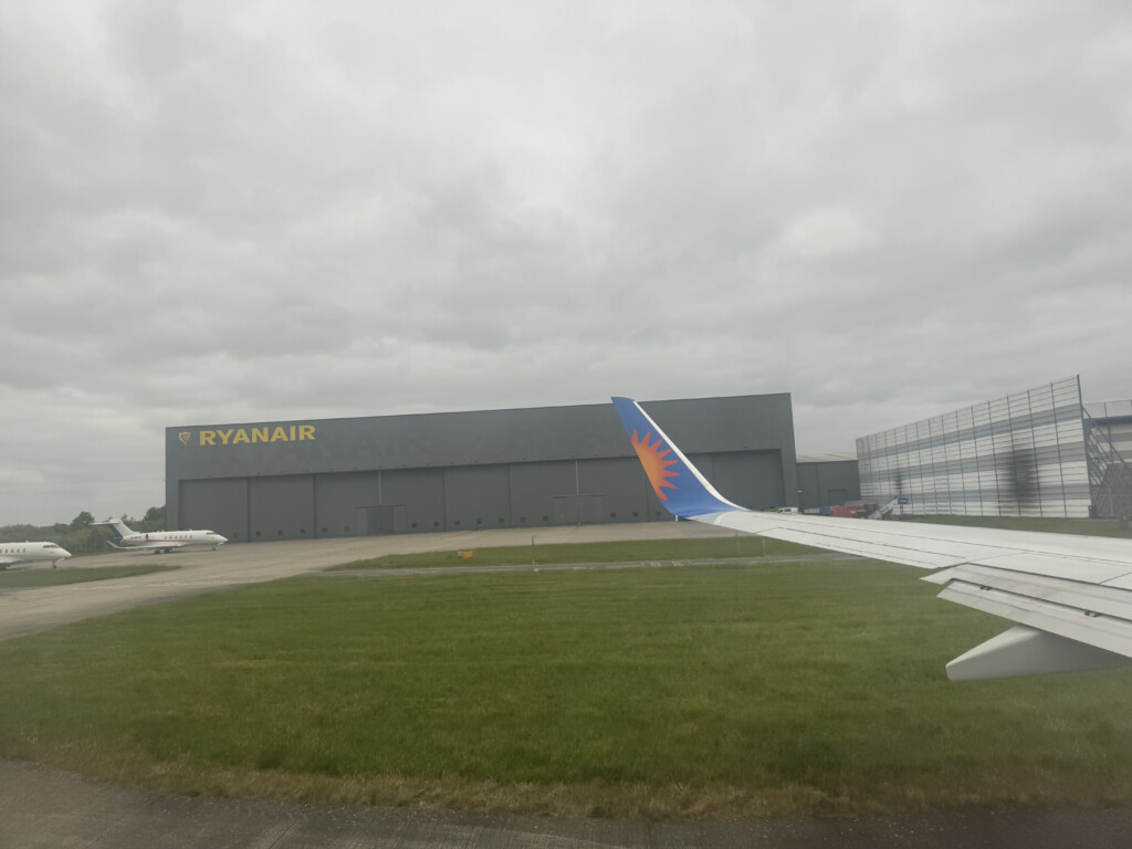 an airplane wing in front of a building