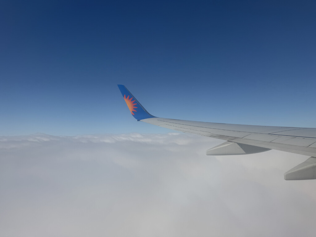 the wing of an airplane above the clouds