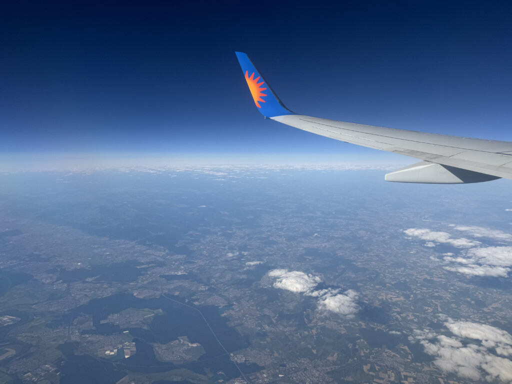 an airplane wing above the earth