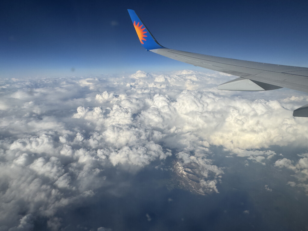 an airplane wing above the clouds