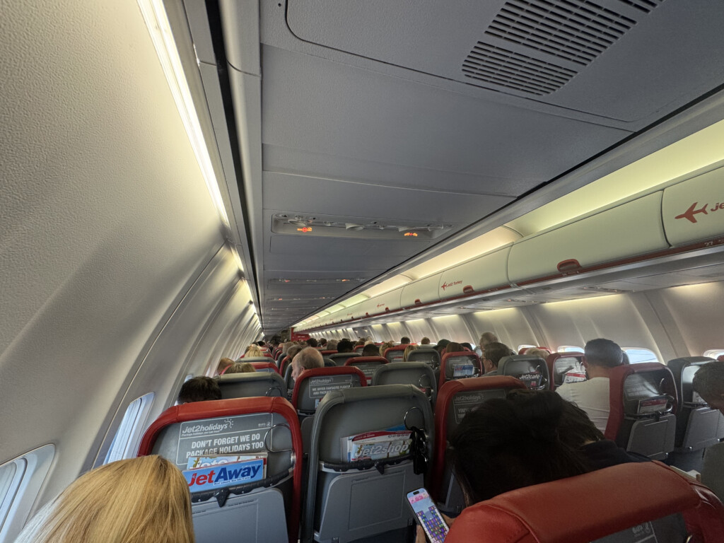 a group of people sitting in an airplane