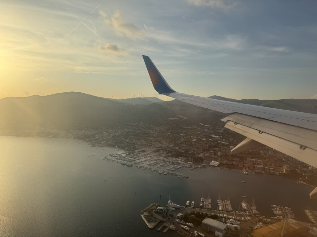 an airplane wing over a body of water