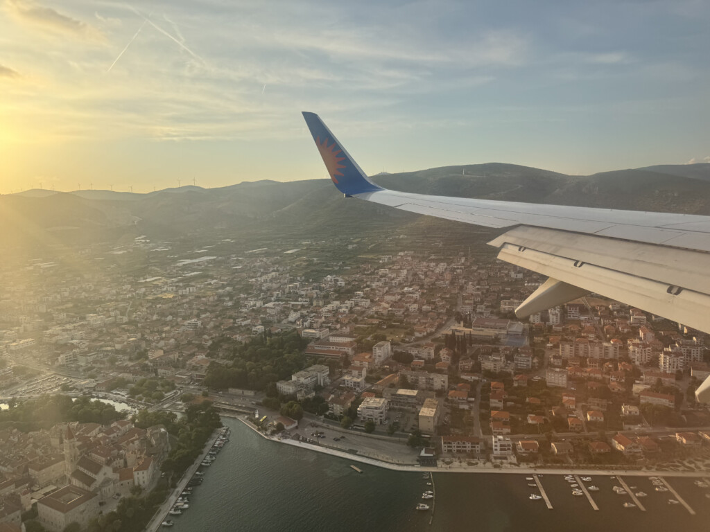 an airplane wing above a city