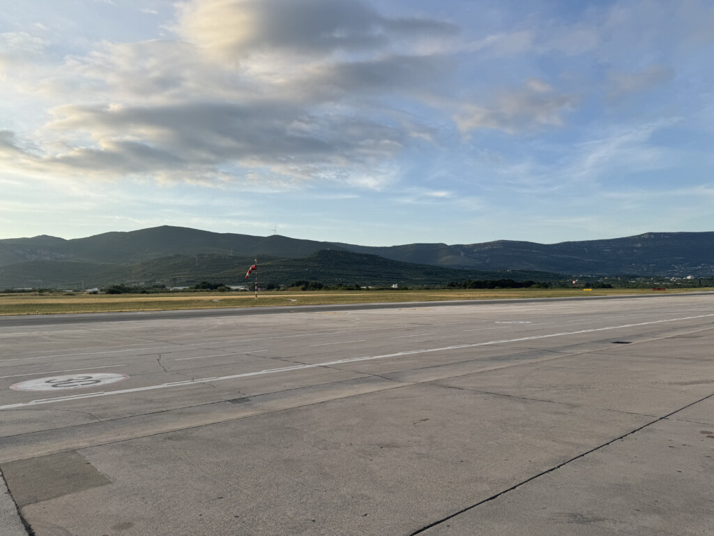 a runway with mountains in the background