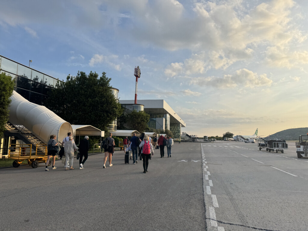 a group of people walking on a runway