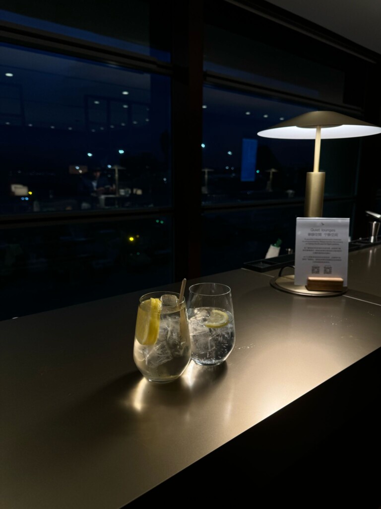 two glasses of ice and lemon on a bar