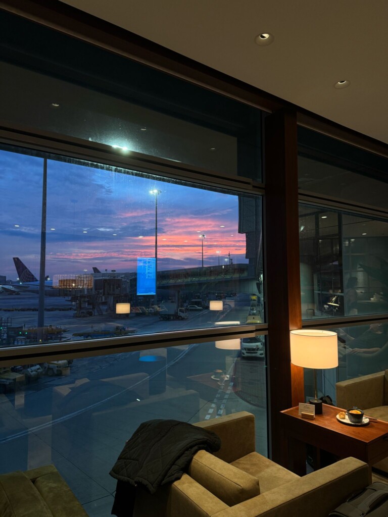 a window with a view of an airport and an airplane