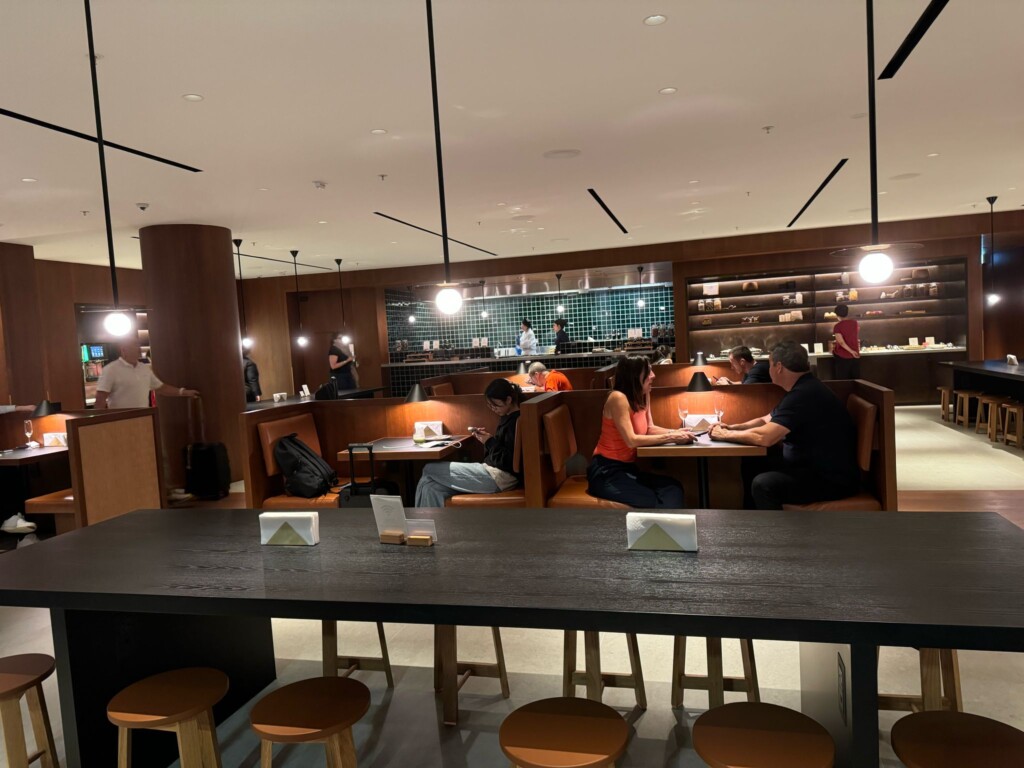 a group of people sitting at tables in a restaurant