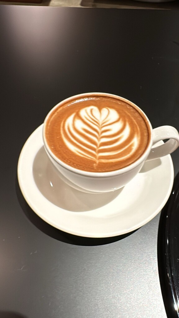 a cup of coffee with a heart shaped foam