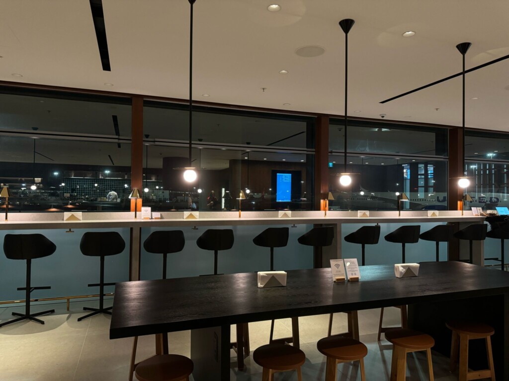 a long table with chairs in a room with windows