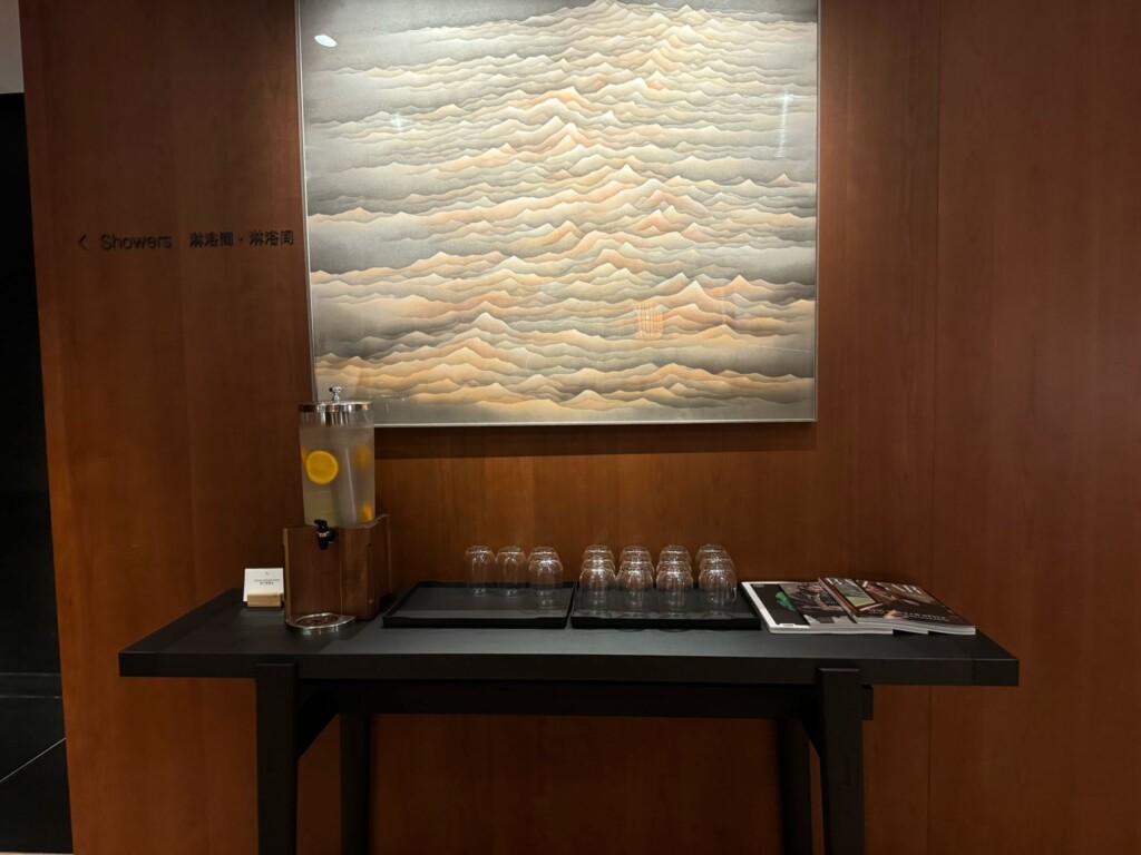 a table with glasses and a drink dispenser on it