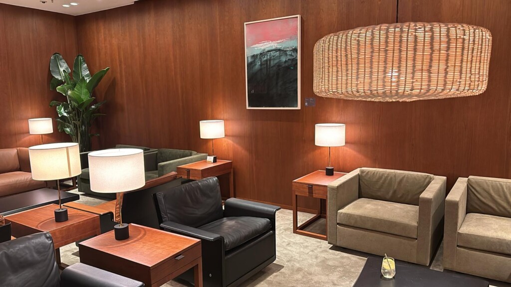 a room with chairs and tables and lamps