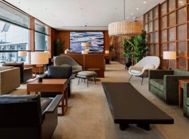 a room with a couch and chairs