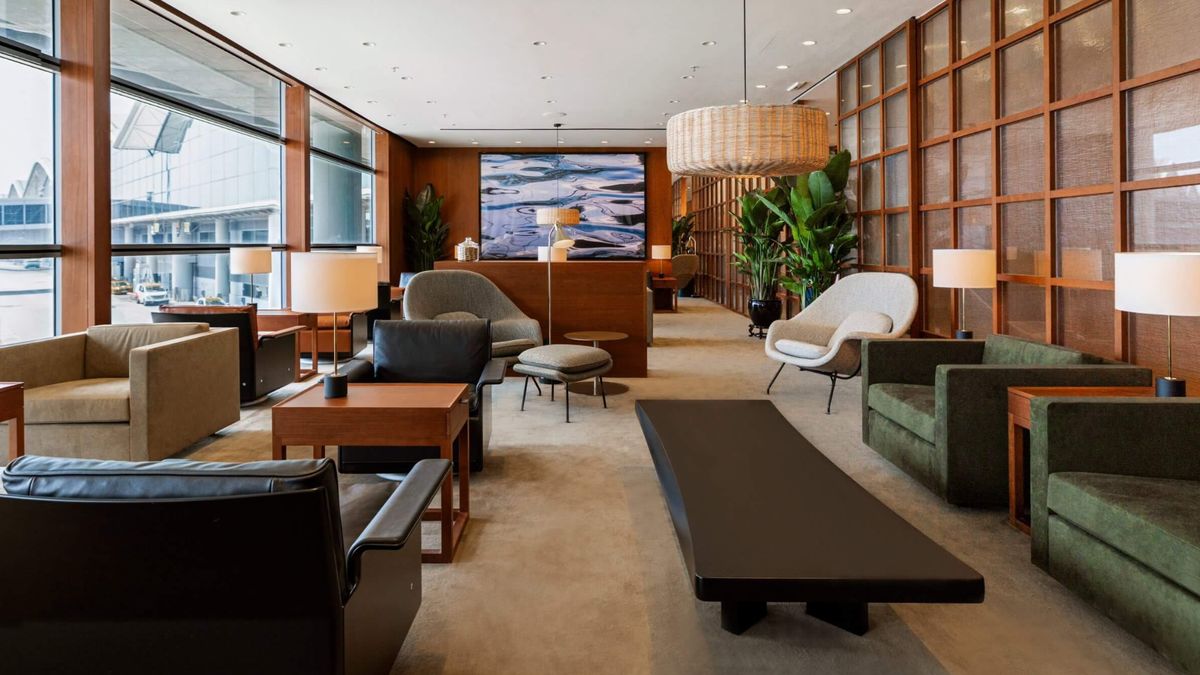 a room with a couch and chairs