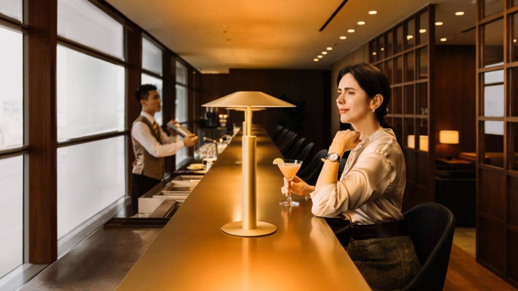 a woman sitting at a bar with a drink