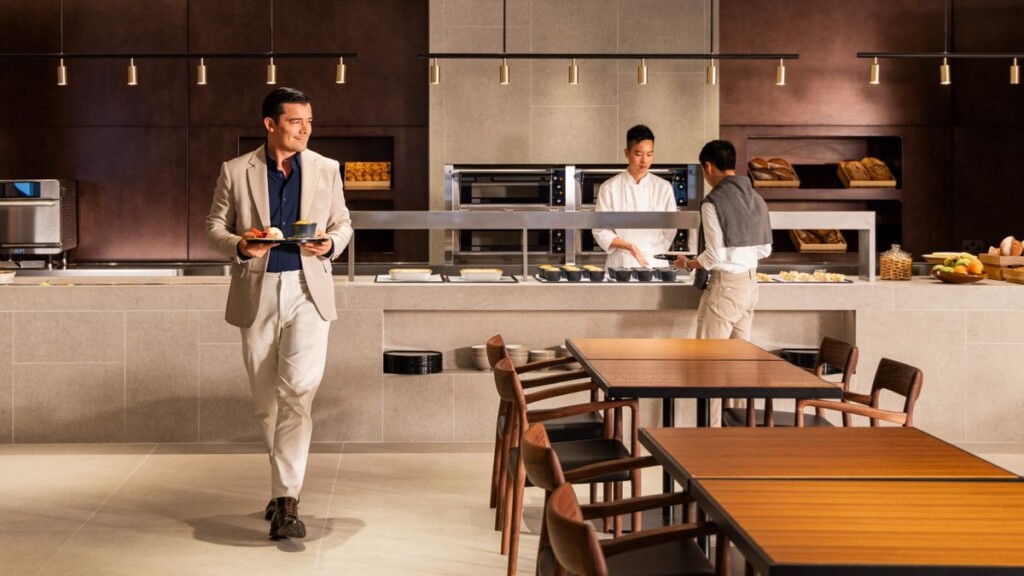 a man in a suit holding a tray with food on it