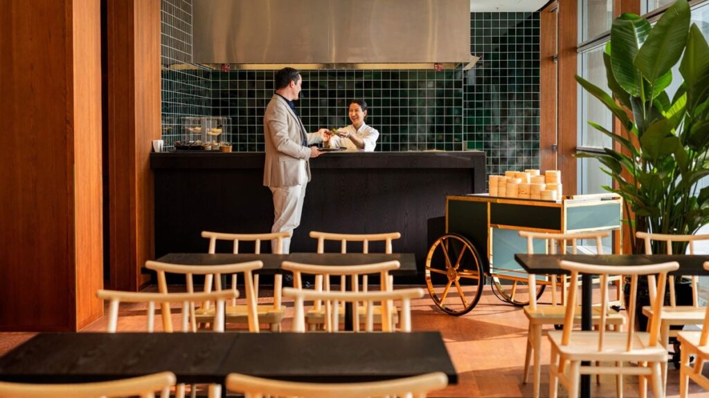 a man standing at a counter in a restaurant