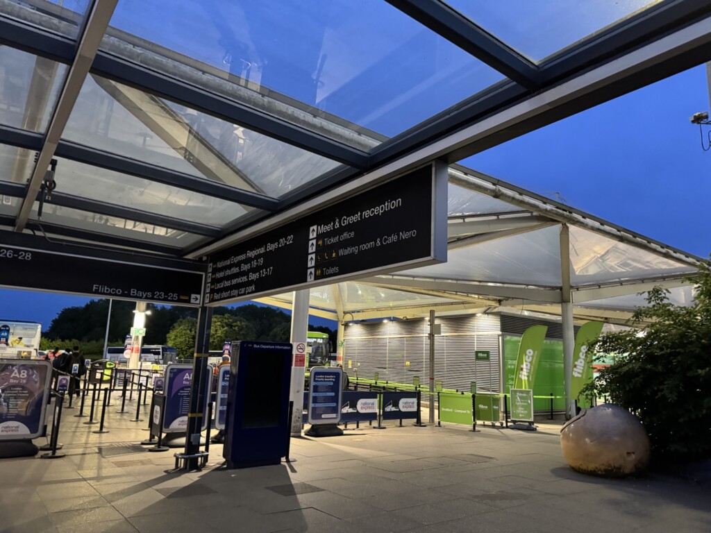 a covered area with a sign and a glass roof