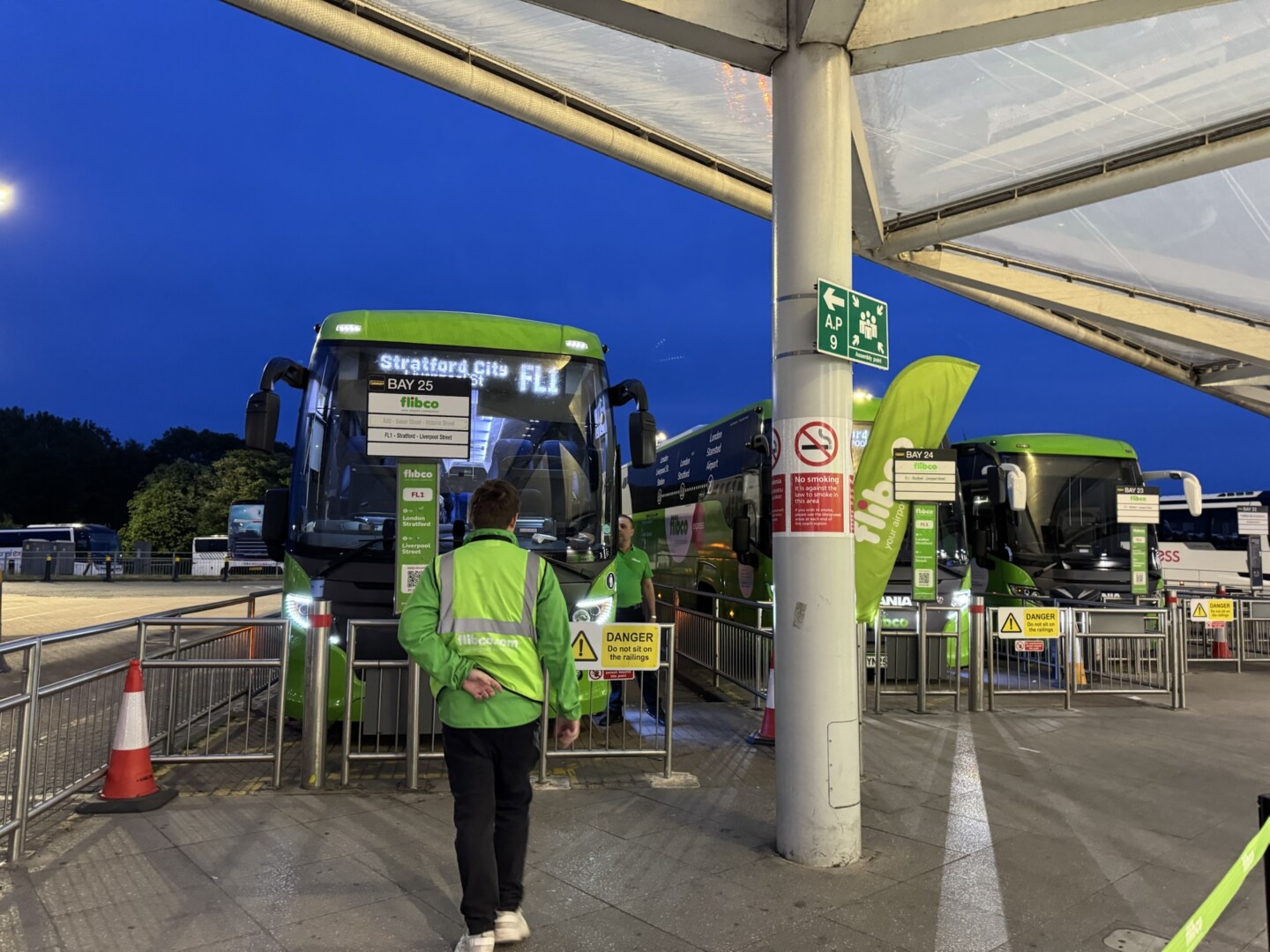 a man standing next to a bus