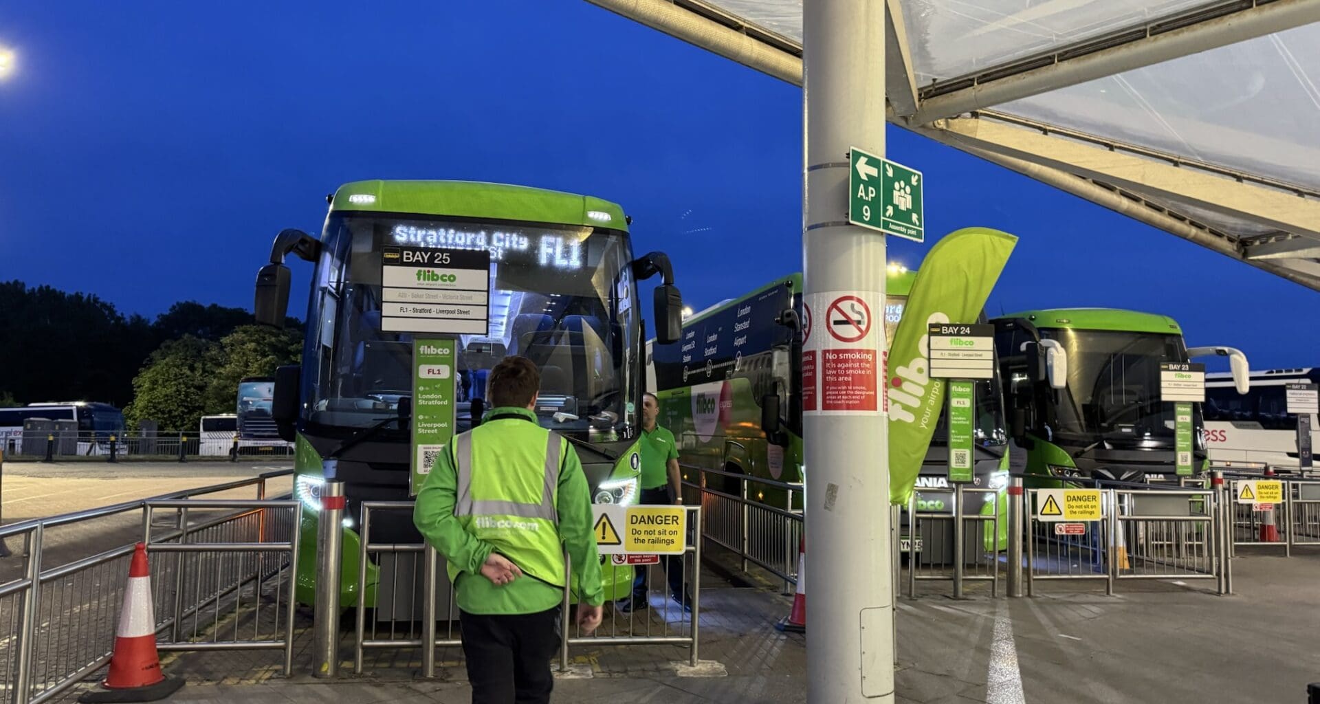 a man standing next to a bus