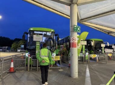 a man standing next to a bus