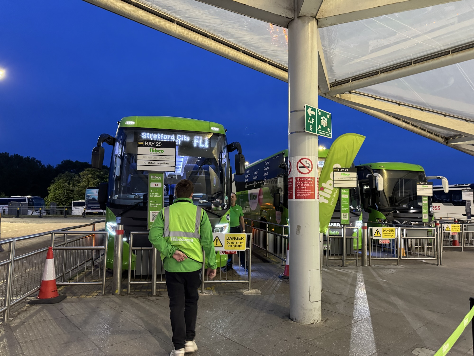 a man standing next to a bus