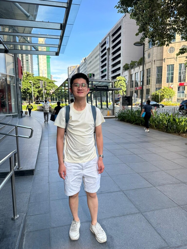 a man standing on a sidewalk