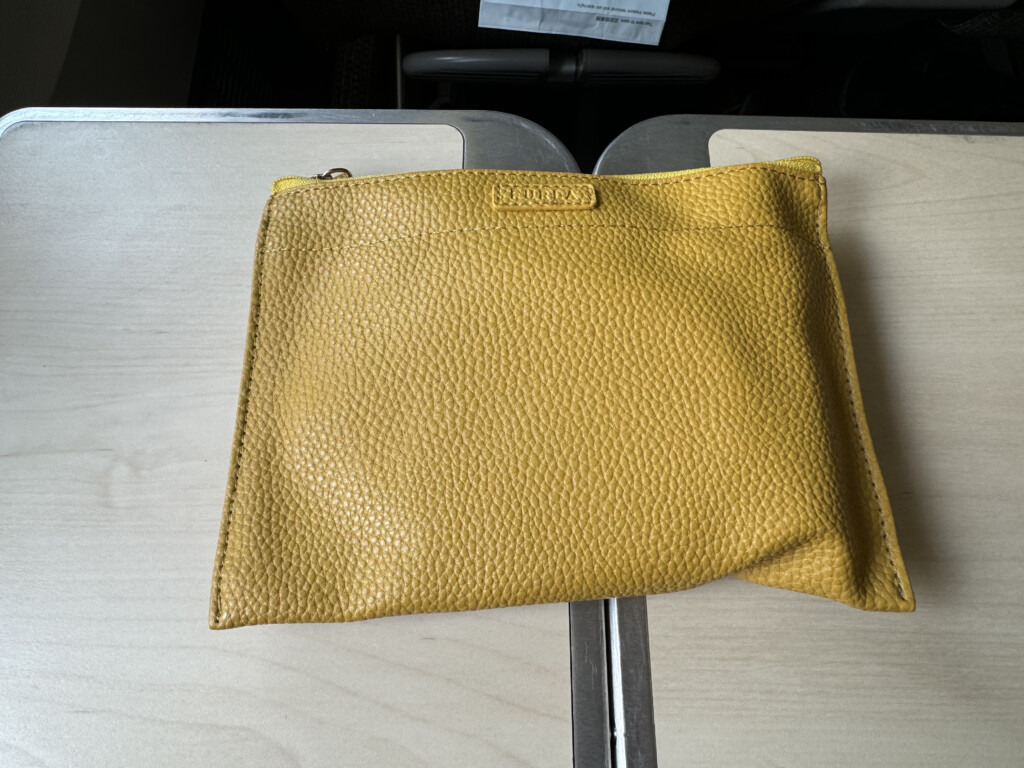 a yellow leather pouch on a table