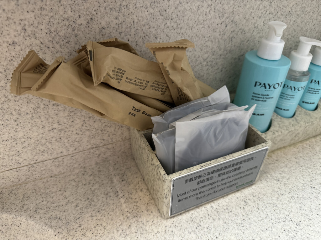 a box with a container of condiments and a bottle of shampoo