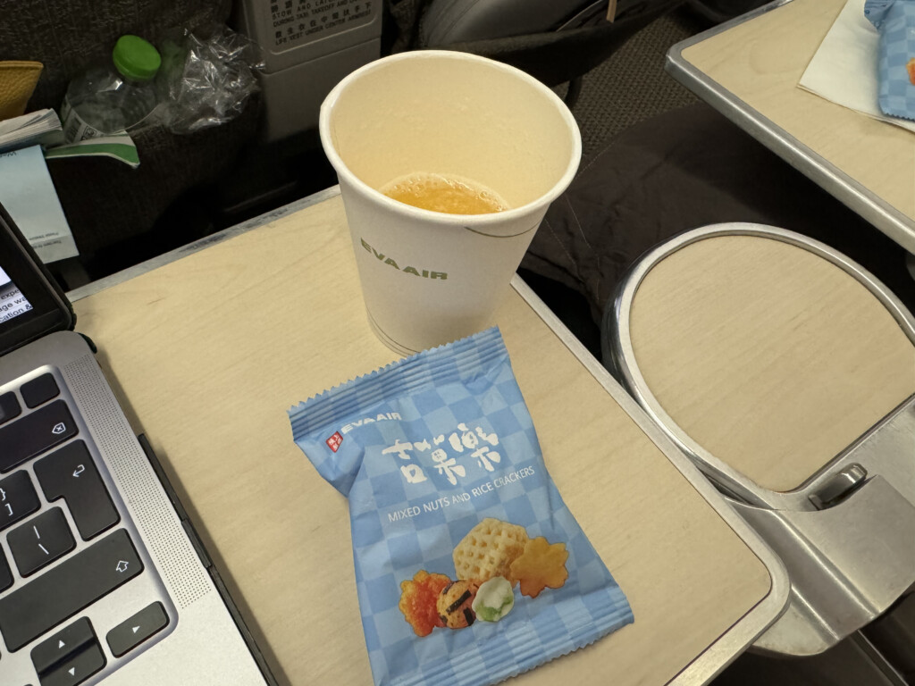 a cup of coffee and a bag of chips on a table