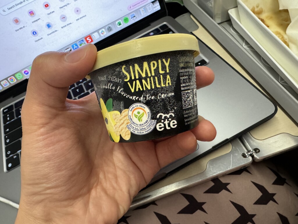 a hand holding a container of food
