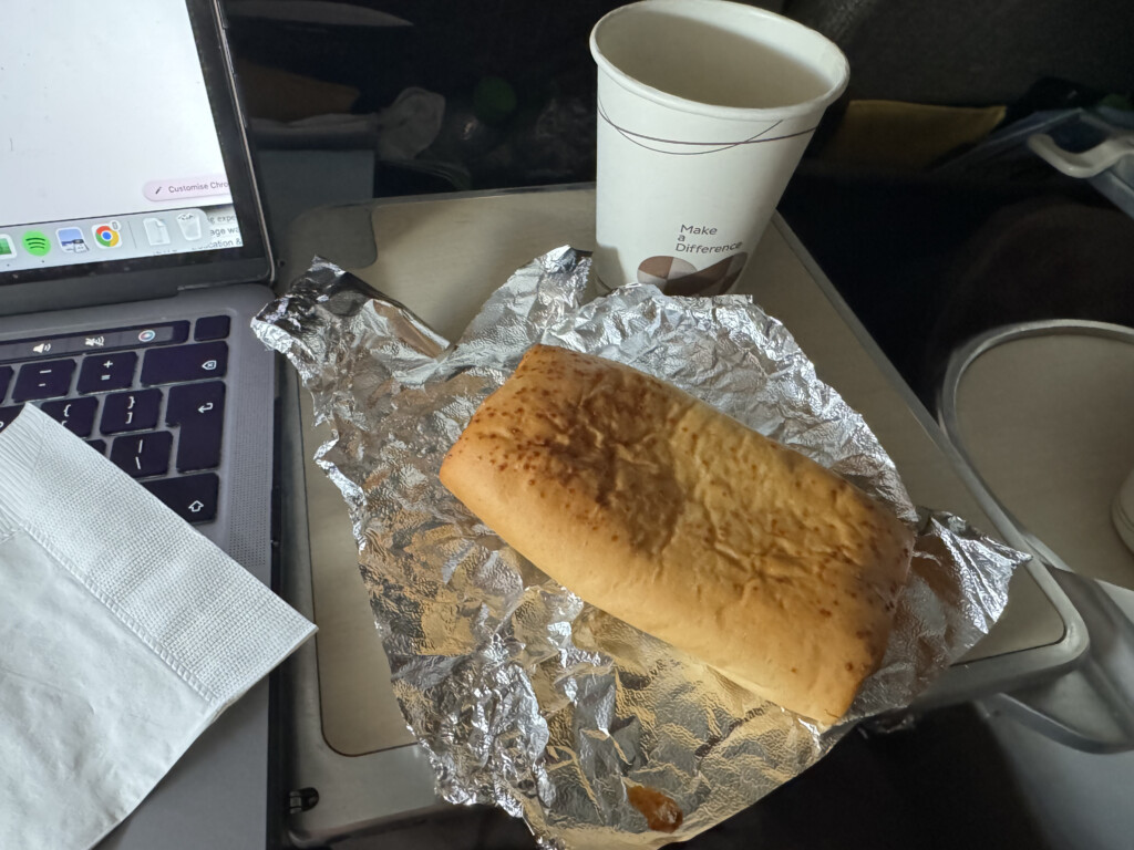 a bread on foil and a cup on a laptop