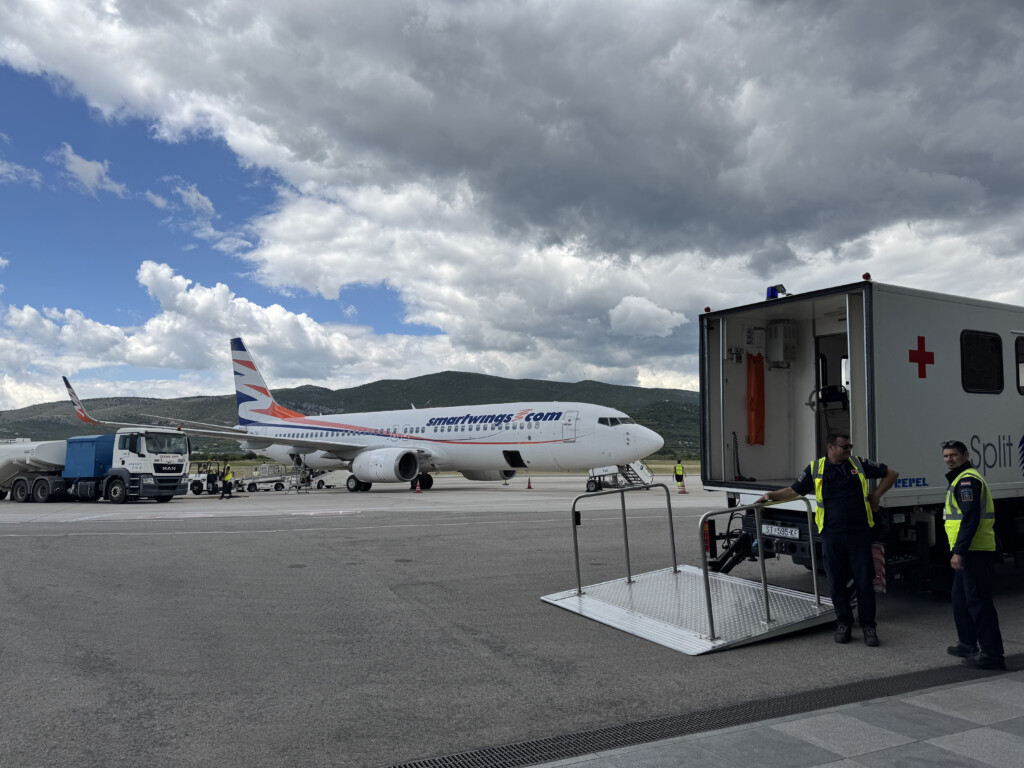 a man standing next to a plane