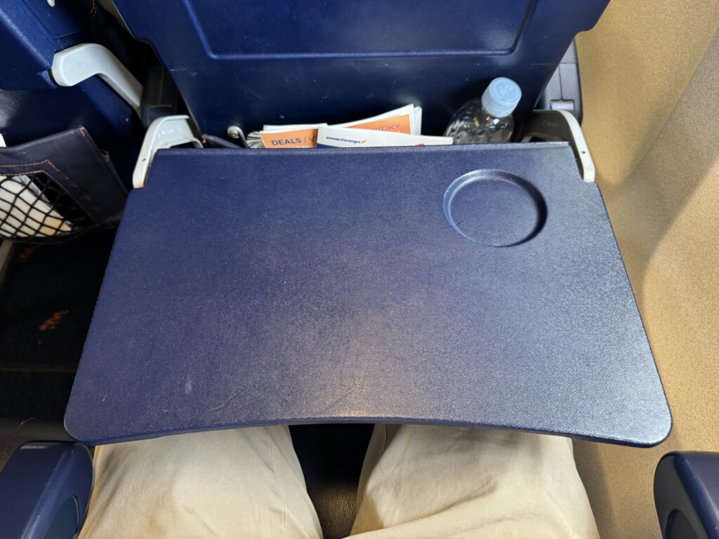 a blue plastic object with a drink bottle in the middle