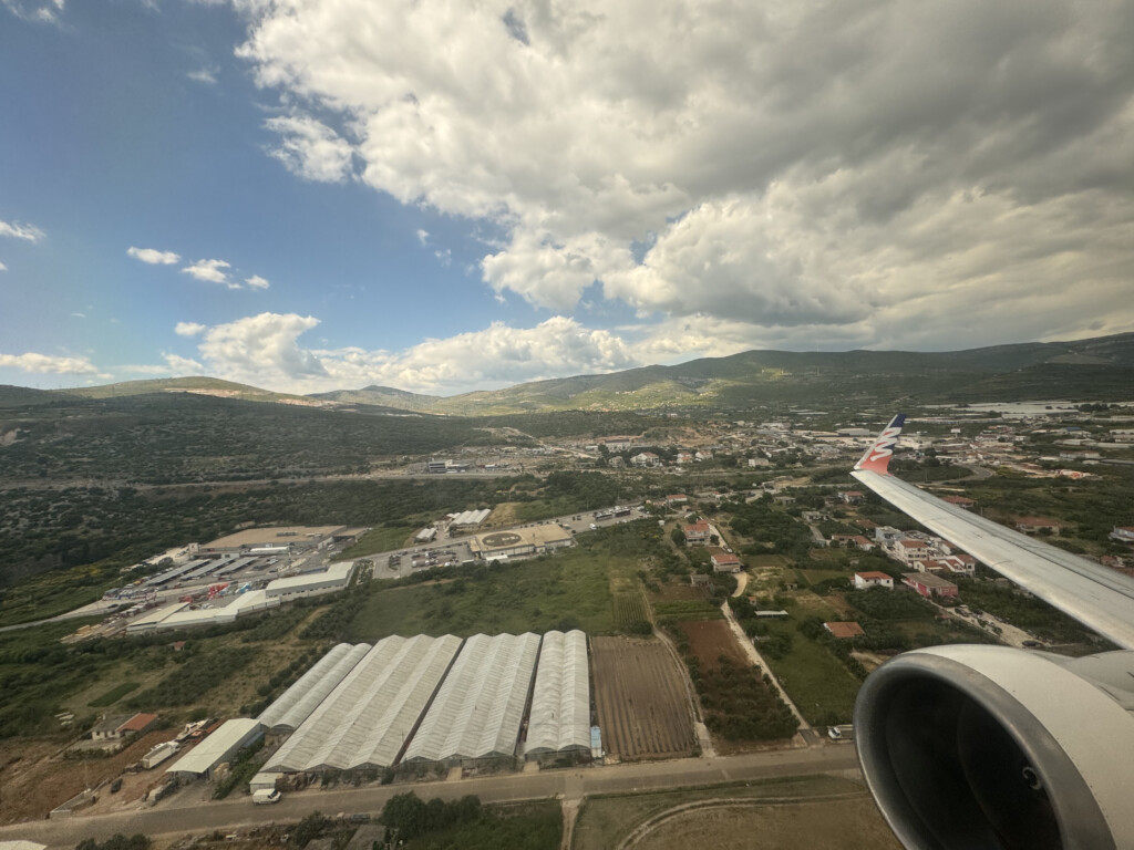 an airplane wing and a city