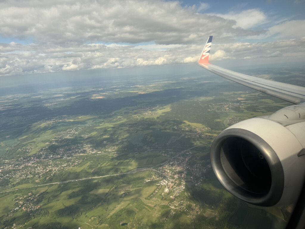 an airplane wing and a landscape