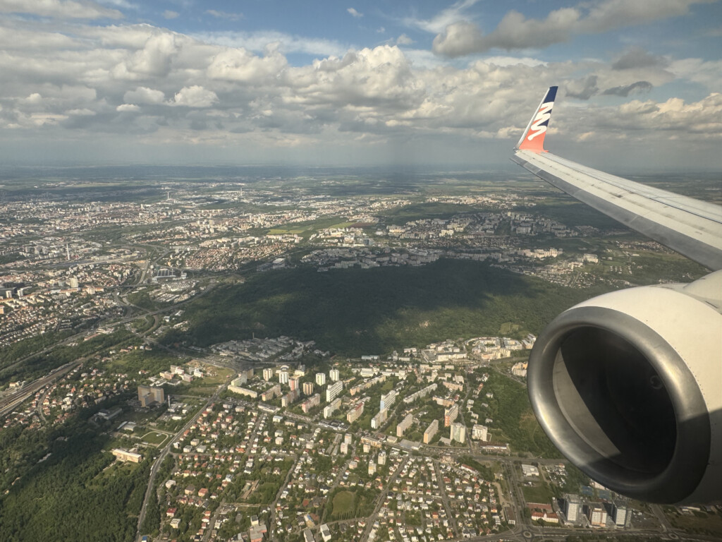 an airplane wing and a city