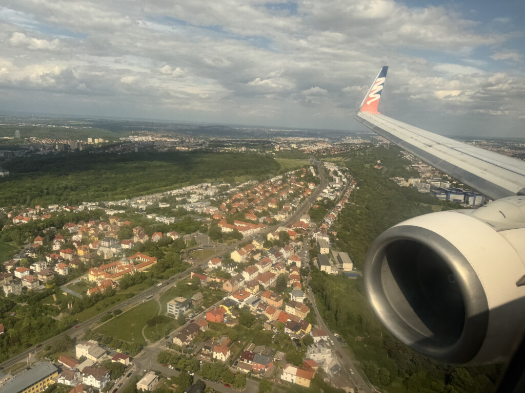 an airplane wing and a city