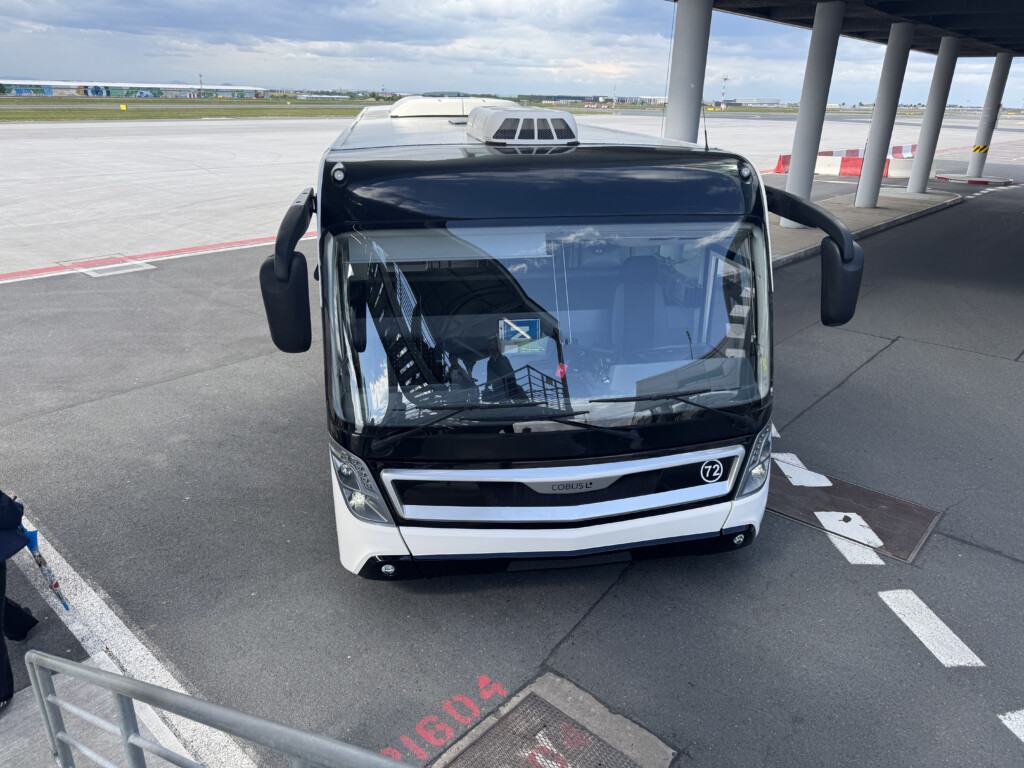 a black and white bus parked on a tarmac