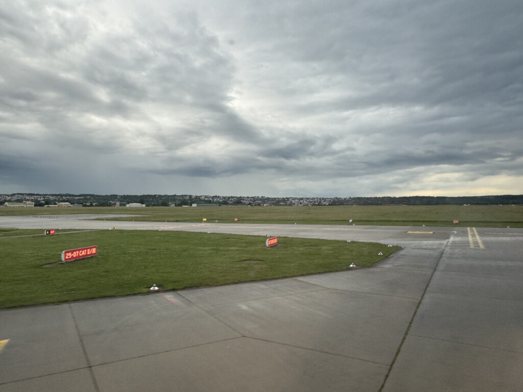 a runway with grass and signs on it