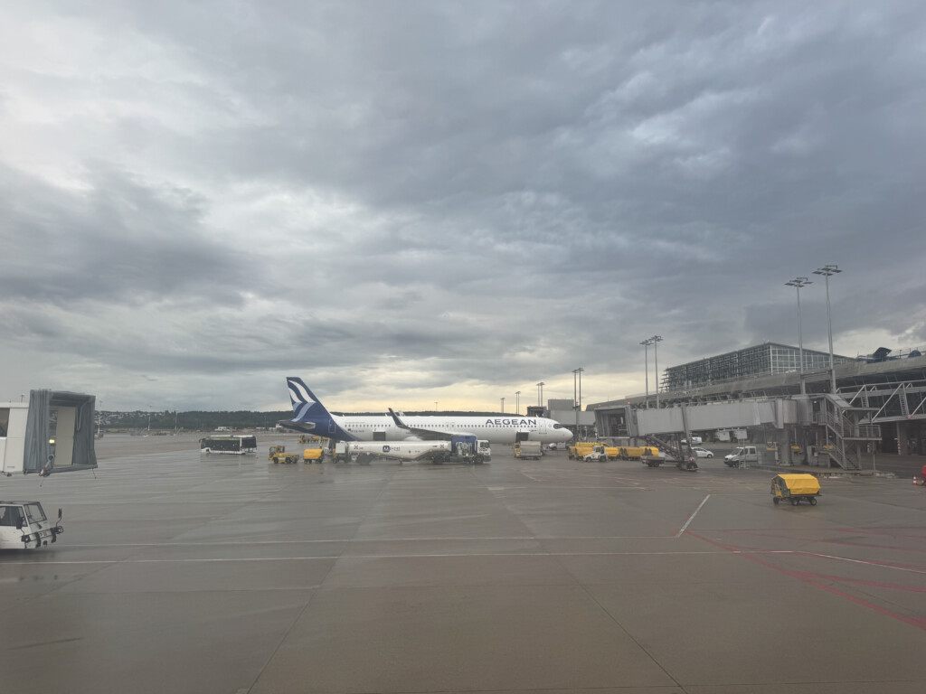 an airport with airplanes and a building