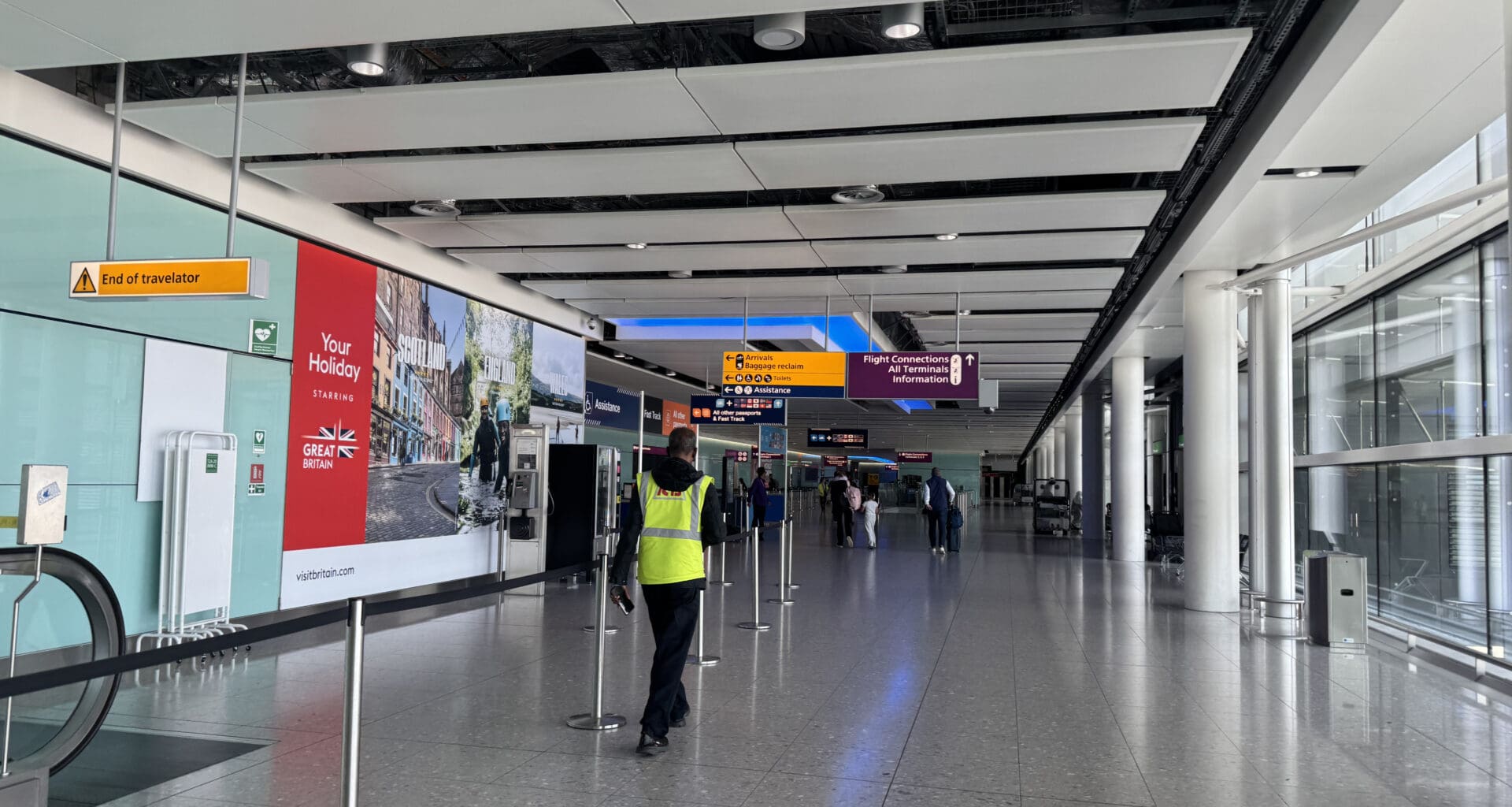 a person in a yellow vest standing in a hallway