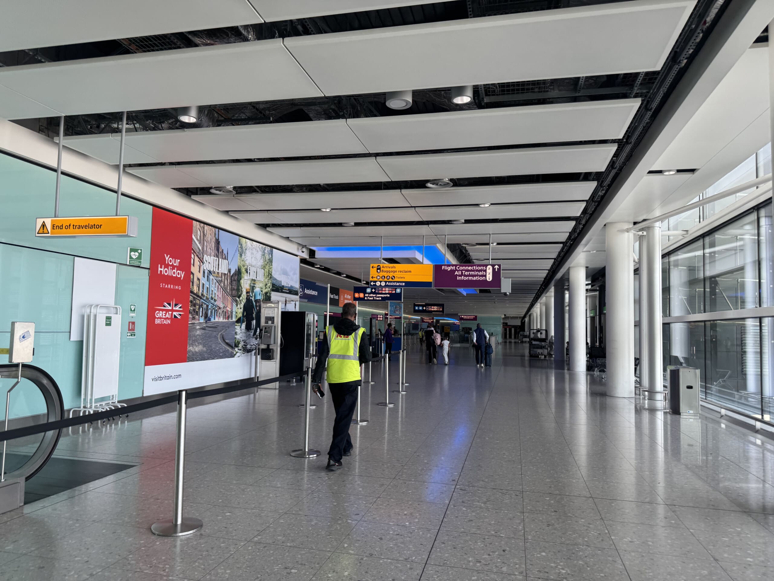 a person in a yellow vest standing in a hallway
