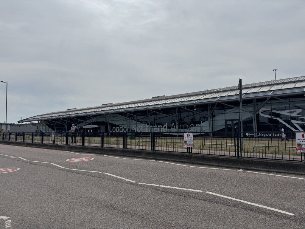 a building with a fence and a road