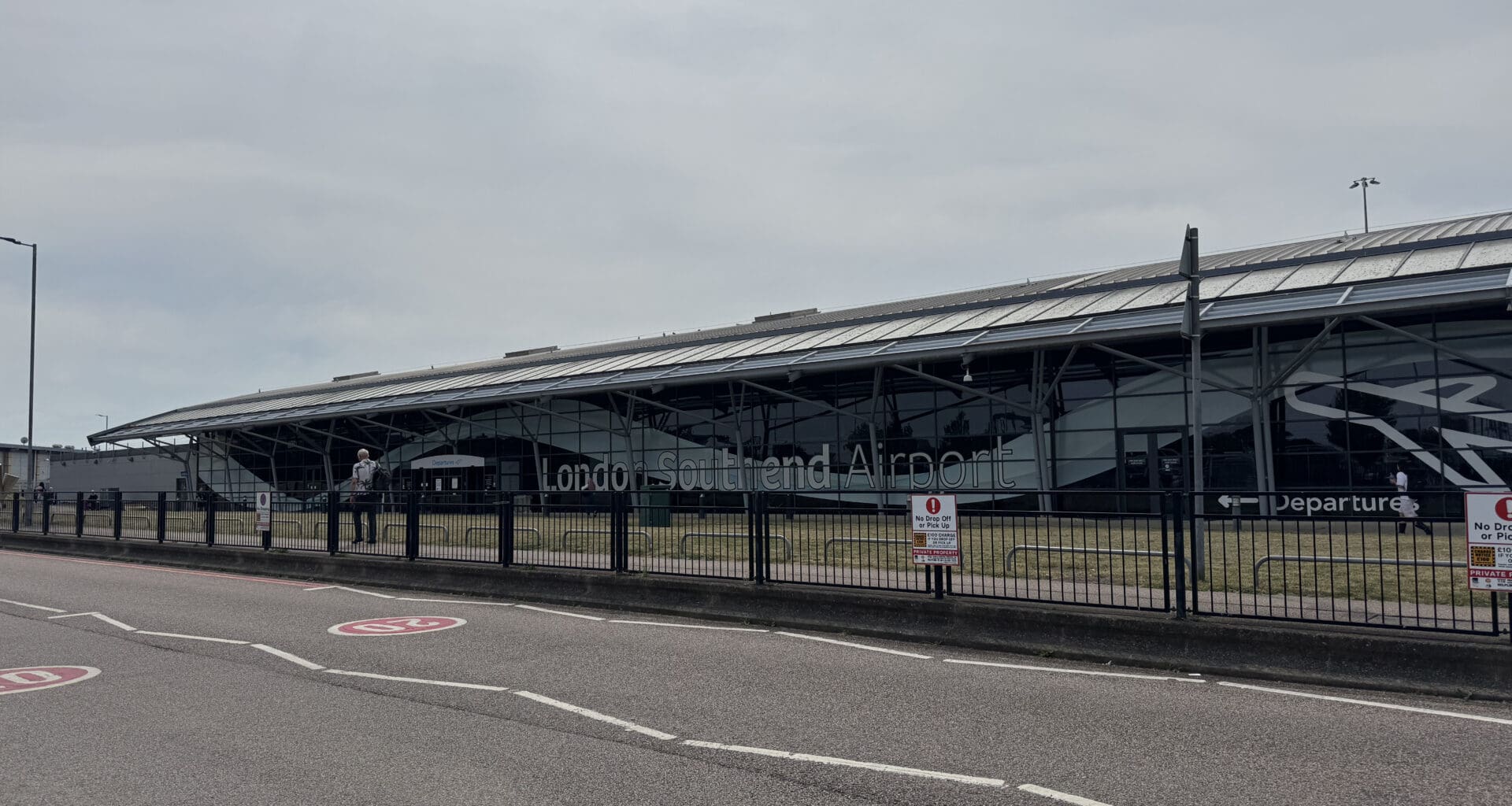 a building with a fence and a road