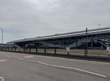 a building with a fence and a road