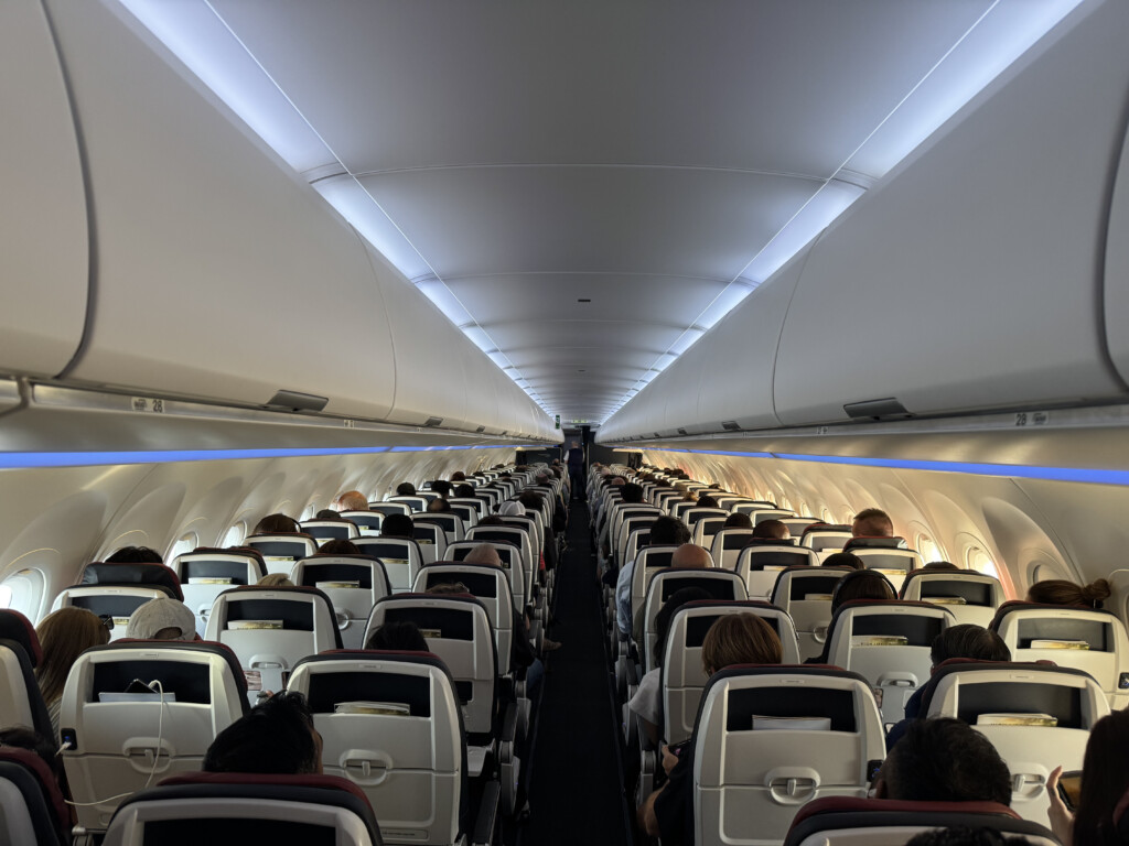 a group of people sitting in an airplane