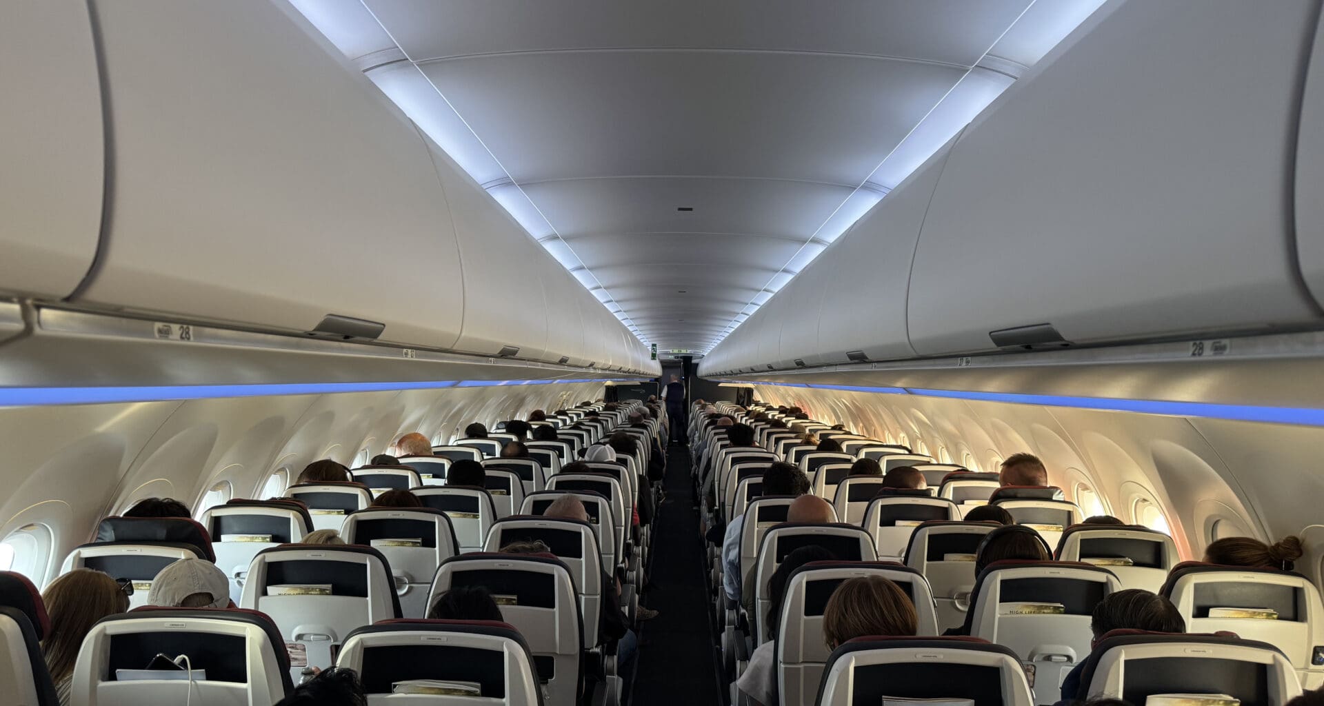 a group of people sitting in an airplane