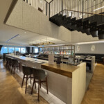 a bar with chairs and a staircase